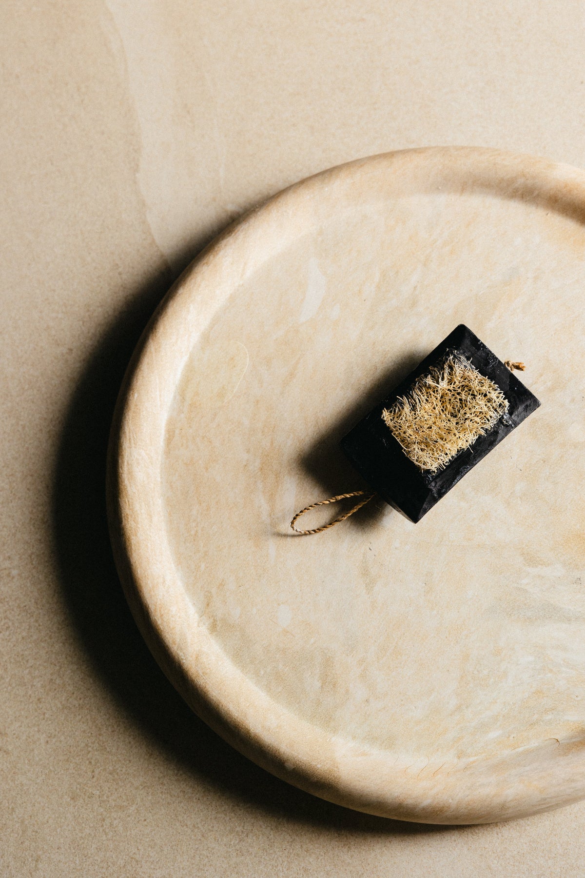 Activated Charcoal Cleanser on a stone dish