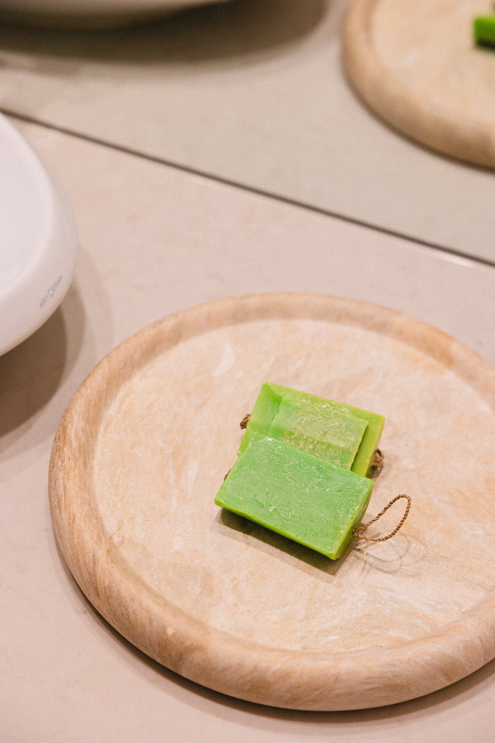 Collagen Boost cleanser bar on a wooden board