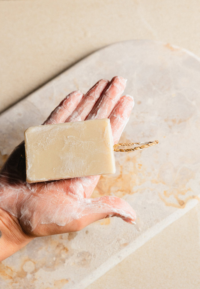 Hand holding a Vanish Envy cleanser bar